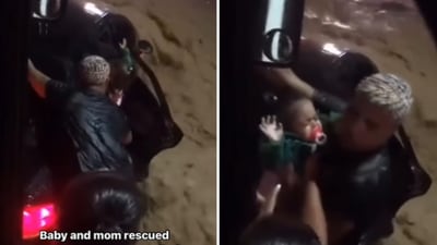 The image shows a man saving a mom and her baby during a flash flood in Brazil. (Instagram/@danuzioneto)