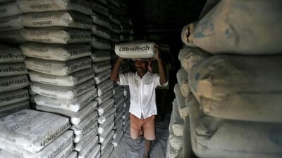A labourer carries a sack of cement inside a shop. (REUTERS)