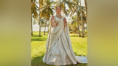 Rakul accessorised the lehenga set with a gold and Kundan choker necklace, layered Kundan necklaces, matching earrings, mang tika, pink bangles, kadhas, gold Kaleeras, and statement rings. A centre-parted bun, shimmery pink eye shadow, mascara on the lashes, darkened brows, rouge on the cheekbones, and a matte base completed the glam picks. (Instagram/@stylebyami) Rakul accessorised the lehenga set with a gold and Kundan choker necklace, layered Kundan necklaces, matching earrings, mang tika, pink bangles, kadhas, gold Kaleeras, and statement rings. A centre-parted bun, shimmery pink eye shadow, mascara on the lashes, darkened brows, rouge on the cheekbones, and a matte base completed the glam picks. (Instagram/@stylebyami)