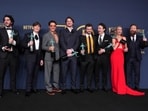 Benny Safdie, from left, Cillian Murphy, Robert Downey Jr, Josh Hartnett, Alden Ehrenreich, Casey Affleck, Emily Blunt, and Kenneth Branagh, winners of the award for the award for outstanding performance by a cast in a motion picture for Oppenheimer, pose in the press room during the 30th annual Screen Actors Guild Awards on February 24, 2024 at the Shrine Auditorium in Los Angeles. (AP)