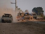Israel-Hamas War: A column of armored Israeli army vehicles drives in southern Israel near the Gaza border. Israel-Hamas War: A column of armored Israeli army vehicles drives in southern Israel near the Gaza border.