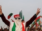 A supporter of former Prime Minister Imran Khan's party, the Pakistan Tehreek-e-Insaf (PTI), wears a cap in the colours of the party flag, at a protest demanding free and fair results of the elections, in Peshawar, Pakistan February 17.