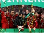  Liverpool manager Juergen Klopp and Virgil van Dijk celebrate winning the Carabao Cup with the trophy and teammates 