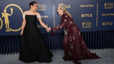 America Ferrera made a grand entrance in a custom black gown from Christian Dior. The floor-length dress featured a small black belt and ivory off-the-shoulder sleeve accents, adding a touch of elegance to her look. (AP) America Ferrera made a grand entrance in a custom black gown from Christian Dior. The floor-length dress featured a small black belt and ivory off-the-shoulder sleeve accents, adding a touch of elegance to her look. (AP)
