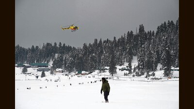 A tourist at the snow-covered ski resort in Gulmarg on Sunday. (Wassem Andrabi/HT) A tourist at the snow-covered ski resort in Gulmarg on Sunday. (Wassem Andrabi/HT)