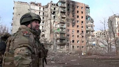 Russian commander walks past damaged buildings, after Russian forces completed their takeover of Avdiivka, eastern Ukraine. (AP)