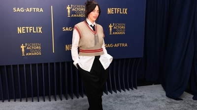 Billie Eilish made a statement on the red carpet in a Vivienne Westwood ensemble. Her outfit included cropped black pants, a white button-down shirt, a knit beige vest, and a skinny black tie.&nbsp; (REUTERS)