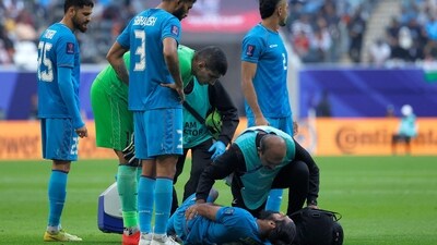 India's staff check on their defender #05 Sandesh Jhingan as he lies on the ground during the Qatar 2023 AFC Asian Cup Group B football match between Syria and India (AFP) India's staff check on their defender #05 Sandesh Jhingan as he lies on the ground during the Qatar 2023 AFC Asian Cup Group B football match between Syria and India (AFP)