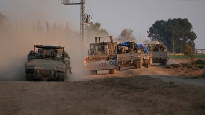 Israel-Hamas War: A column of armored Israeli army vehicles drives in southern Israel near the Gaza border. (AP)