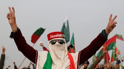 A supporter of former Prime Minister Imran Khan's party, the Pakistan Tehreek-e-Insaf (PTI), wears a cap in the colours of the party flag, at a protest demanding free and fair results of the elections, in Peshawar, Pakistan February 17. (REUTERS)
