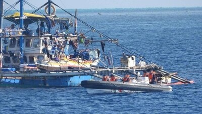 This handout photo taken on February 22, 2024 and received on February 25, 2024 from the Philippine Coast Guard shows China Coast Guard personnel onboard a rigid-hulled inflatable boat (R) as they shadow a Philippine fishing boat (L) during the Philippine Bureau of Fisheries and Aquatic Resources (BFAR) mission to bring supplies to fishermen near the China-controlled Scarborough Shoal in the disputed South China Sea. (AFP) This handout photo taken on February 22, 2024 and received on February 25, 2024 from the Philippine Coast Guard shows China Coast Guard personnel onboard a rigid-hulled inflatable boat (R) as they shadow a Philippine fishing boat (L) during the Philippine Bureau of Fisheries and Aquatic Resources (BFAR) mission to bring supplies to fishermen near the China-controlled Scarborough Shoal in the disputed South China Sea. (AFP)