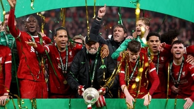 Liverpool manager Juergen Klopp and Virgil van Dijk celebrate winning the Carabao Cup with the trophy and teammates (REUTERS)