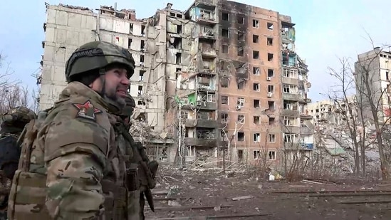 Russian commander walks past damaged buildings, after Russian forces completed their takeover of Avdiivka, eastern Ukraine. (AP)