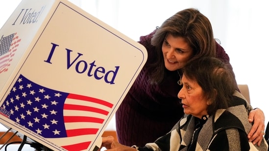 Republican presidential candidate former UN Ambassador Nikki Haley helps her mother Raj Kaur Randhawa to the voting booth Saturday, Feb. 24, 2024, in Kiawah Island, S.C. (AP Photo/Chris Carlson) (AP)
