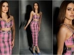 Nushrratt Bharuccha is a total stunner who always hits the fashion targets like a pro. Be it a mini dress or a chic pantsuit, this stylish diva can rock any look to perfection. Whenever she posts a picture, she is sure to cause a stir in the fashion world. This time around, she wore a checkered printed pink coordinated set that is simply stunning, but what really caught the eyes of fashionistas was the trendy bow pattern that adorns her outfit, making it a complete showstopper. With her incredible fashion sense and undeniable beauty, she has her fans swooning and us unable to look away. Scroll down to take style notes.(Instagram/@nushrrattbharuccha)