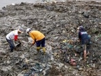 Scavengers pick up plastic and metal wastes in the soil.(AFP)