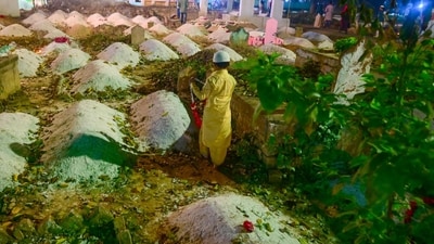 Muslims pray at their relatives' graves on the occasion of Shab-e-Barat in Prayagraj on Sunday. (AFP)