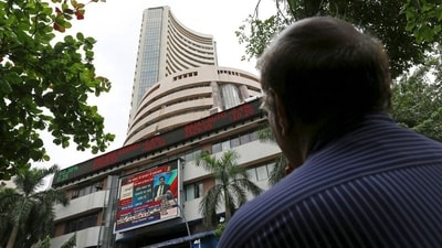 A man looks at a screen across a road displaying the Sensex on the facade of the Bombay Stock Exchange (BSE) building in Mumbai. (REUTERS/FILE)