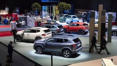 Attendees, including journalists and guests, explore the exhibition hall during a media day at the 91st Geneva International Motor Show (GIMS). (AP)
