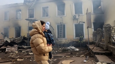 A local resident and her child walks past the railway station destroyed by a Russian missile attack in Konstyantynivka, Donetsk region, on February 25, 2024, amid the Russian invasion of Ukraine. (Photo by Anatolii STEPANOV / AFP) (AFP) A local resident and her child walks past the railway station destroyed by a Russian missile attack in Konstyantynivka, Donetsk region, on February 25, 2024, amid the Russian invasion of Ukraine. (Photo by Anatolii STEPANOV / AFP) (AFP)