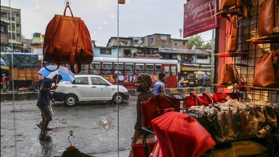 Passing pedestrians and traffic are seen through the window of a leather goods stores in the Dharavi area of Mumbai, India, on Tuesday, July 18, 2017. India's new goods and services tax, introduced on July 1, classified leather products as luxury items and raised the rate to 28 percent -- more than double the 13.5 percent tax levied until June 30. The leather sector is just one example of how India's vast informal economy -- which accounts for more than 90 percent of the workforce -- is struggling under India's new tax rates, which range widely from exemptions for items like basic food grains to 28 percent for products like air conditioners. Photographer: Dhiraj Singh/Bloomberg (Bloomberg)
