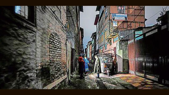 Residents in a dark alley during a power outage in Srinagar. (AP File)