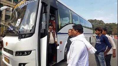 Congress MLAs arrive in a bus to cast their votes for the Rajya Sabha elections, at Vidhana Soudha, in Bengaluru on Tuesday. (PTI) Congress MLAs arrive in a bus to cast their votes for the Rajya Sabha elections, at Vidhana Soudha, in Bengaluru on Tuesday. (PTI)