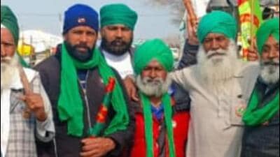 Karnail Singh (in red jacket) of Patiala district with farmers protesting at the Khanauri border last week. (HT Photo)