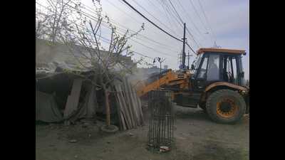 MC team demolishing illegal structures in Ludhiana. (HT)