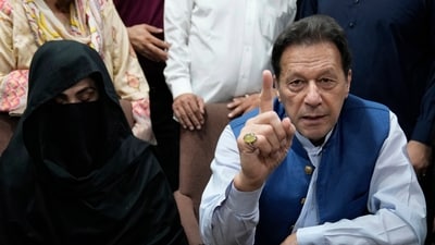 Pakistan's former Prime Minister Imran Khan, right, and Bushra Bibi,his wife (AP)