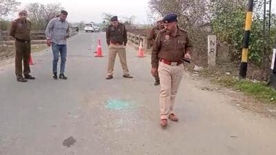 Police personnel at the site of Sunday’s shooting in Bahadurgarh in which INLD Haryana unit chief Nafe Singh Rathee and a party worker were killed. (HT Photo)