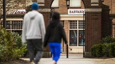 Pedestrians walk through Harvard Yard on the closed Harvard University campus in Cambridge, Massachusetts, US. (Bloomberg)