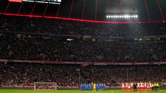 Players observe a minute of silence for former player Andreas Brehme during the German Bundesliga soccer match between FC Bayern Munich and RB Leipzig at the Allianz Arena in Munich, Germany, Feb. 24, 2024. (AP Photo/Matthias Schrader) (AP)