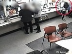 Man in red circle trying to rob UK post office with the help of a spoon. Man in red circle trying to rob UK post office with the help of a spoon.