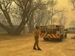 The sprawling blaze was part of a cluster of fires that burned out of control and threatened rural towns. The sprawling blaze was part of a cluster of fires that burned out of control and threatened rural towns.