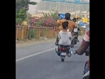 Bengaluru: Men performing wheelie on busy Yelahanka road. Bengaluru: Men performing wheelie on busy Yelahanka road.