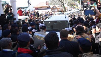 Congress workers trying to stop the vehicles of party MLAs who cross-voted in Tuesday’s Rajya Sabha election as they return to the Himachal Pradesh assembly in Shimla on Wednesday. (Deepak Sansta/HT)