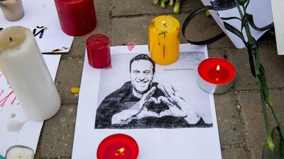Candles surround a portrait of Alexei Navalny (AFP)