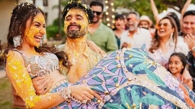 While Rakul donned a blue and purple anarkali and a matching crop top, Jackky was seen lifting the bride (Instagram) While Rakul donned a blue and purple anarkali and a matching crop top, Jackky was seen lifting the bride (Instagram)