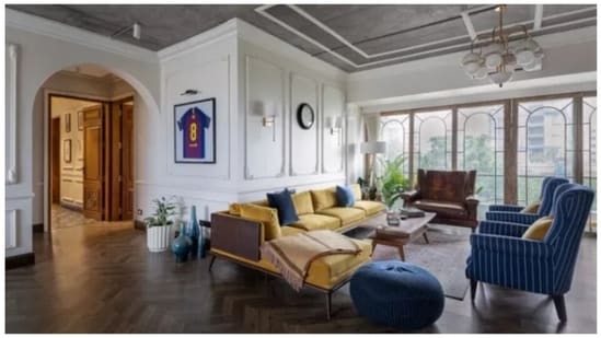 The understated black and white colour palette of the rest of the house is boldly defied by an L-shaped mustard couch and blue sofas in Alia Bhatt and Ranbir Kapoor's living room. The floor-to-ceiling windows and the open design of the space ensures that the room has ample natural light. This was also where most of Alia and Ranbir's wedding festivities were held in April 2022.