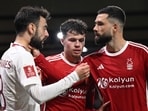 Nottingham Forest's Brazilian defender Felipe (R) holds Manchester United's Portuguese midfielder Bruno Fernandes by the neck.