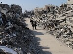 Palestinians walk through the destruction from the Israeli offensive in Jabaliya refugee camp in the Gaza Strip on February 29. Palestinians walk through the destruction from the Israeli offensive in Jabaliya refugee camp in the Gaza Strip on February 29.