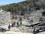 Residents and rescuers check the destruction after an overnight Israeli bombardment in the southern Lebanese village of Kafra, on February 29, 2024, amid ongoing cross-border tensions as fighting continues between Israel and Palestinian Hamas militants in the Gaza Strip.
