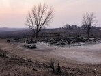 The charred remains of a home burned by the Smokehouse Creek Fire are seen Wednesday, Feb. 28, 2024, in Canadian, Texas. (AP Photo/Julio Cortez)