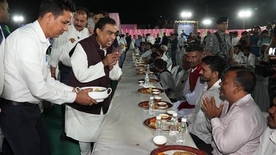 In this photo, Mukesh Ambani, chairman at Reliance Industries, can be seen attending to guests during ‘anna seva’ (community food service) to seek blessings from various community members for the pre-wedding celebration of his son Anant Ambani and Radhika Merchant in Jamnagar. (AFP) In this photo, Mukesh Ambani, chairman at Reliance Industries, can be seen attending to guests during ‘anna seva’ (community food service) to seek blessings from various community members for the pre-wedding celebration of his son Anant Ambani and Radhika Merchant in Jamnagar. (AFP)