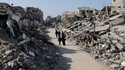 Palestinians walk through the destruction from the Israeli offensive in Jabaliya refugee camp in the Gaza Strip on February 29. (AP) Palestinians walk through the destruction from the Israeli offensive in Jabaliya refugee camp in the Gaza Strip on February 29. (AP)