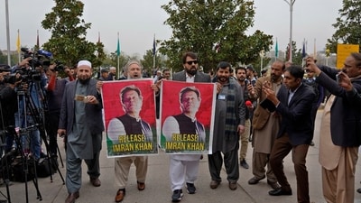 Pakistan's newly elected lawmakers displays a poster of their leader and imprisoned former Prime Minister Imran Khan as they arrive to attend opening session of the Parliament, in Islamabad, Pakistan. (AP)
