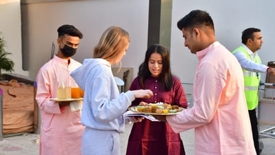 Members of the bridal party offered sweets and drinks to guests who reached the Jamnagar airport early Thursday morning. Ushering in the much-awaited wedding, the Ambani family has also facilitated the construction of new temples within a sprawling temple complex in Jamnagar, Gujarat. Members of the bridal party offered sweets and drinks to guests who reached the Jamnagar airport early Thursday morning. Ushering in the much-awaited wedding, the Ambani family has also facilitated the construction of new temples within a sprawling temple complex in Jamnagar, Gujarat. 