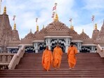 Hindu monks walk down the stairs of the first stone-built Hindu temple in Abu Mureikha, 40 kms, 25 miles, northeast of Abu Dhabi, United Arab Emirates