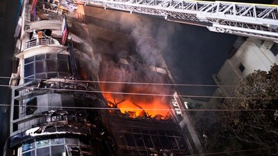 Firefighters used cranes to rescue people from the charred building, said fire officials, who were still working to clear debris and douse any remaining embers. (AP) Firefighters used cranes to rescue people from the charred building, said fire officials, who were still working to clear debris and douse any remaining embers. (AP)